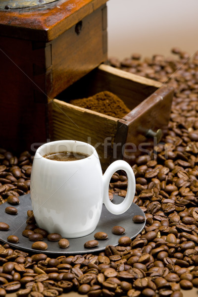 detail of coffee mill with coffee beans and cup of coffee Stock photo © phbcz