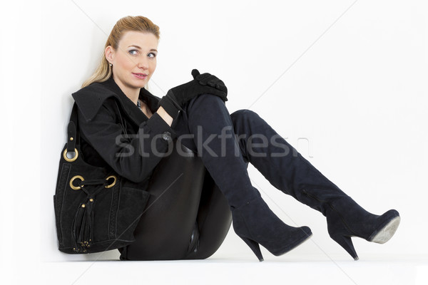 Sitzung Frau tragen schwarz Kleidung Stiefel Stock foto © phbcz