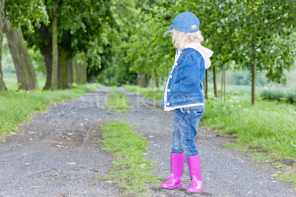 Petite fille bottes en caoutchouc printemps allée fille Photo stock © phbcz