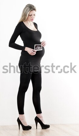 pregnant woman with a sonogram of her baby Stock photo © phbcz