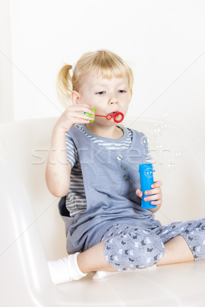 little girl playing with a bubbles maker Stock photo © phbcz