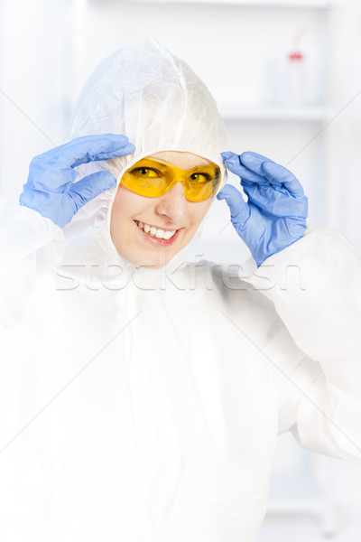 young woman with protective glasses and coat in laboratory Stock photo © phbcz