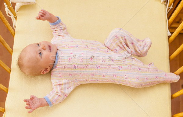 lying two month old baby girl in cot Stock photo © phbcz