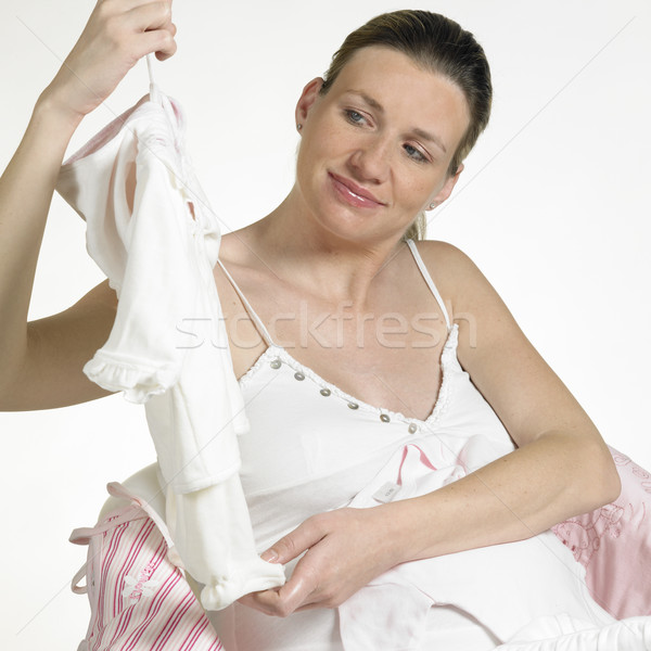 pregnat woman with clothes for babies Stock photo © phbcz