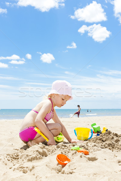 little girl playing on the beach at sea Stock photo © phbcz