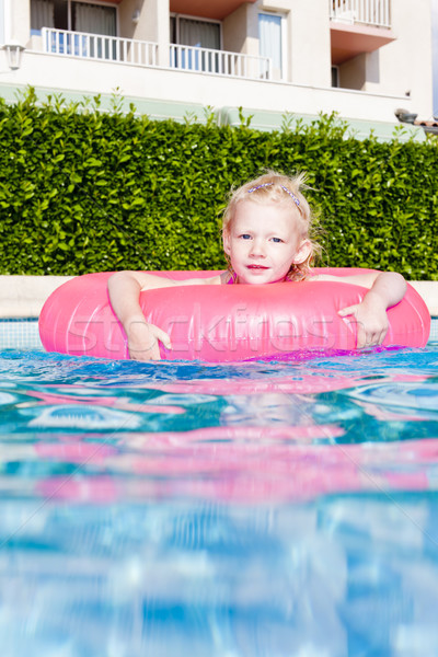 little girl with rubber ring in swimming pool Stock photo © phbcz