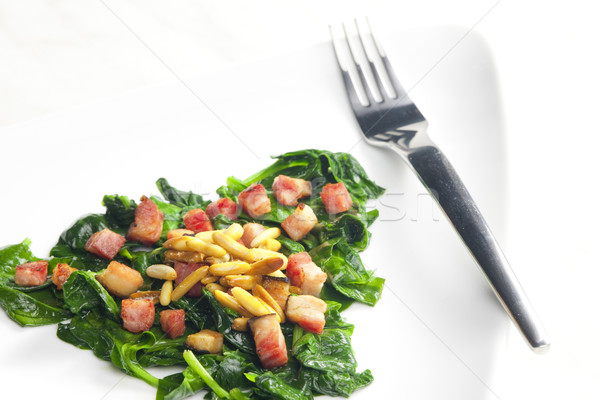 fried spinach with bacon and pine nuts Stock photo © phbcz