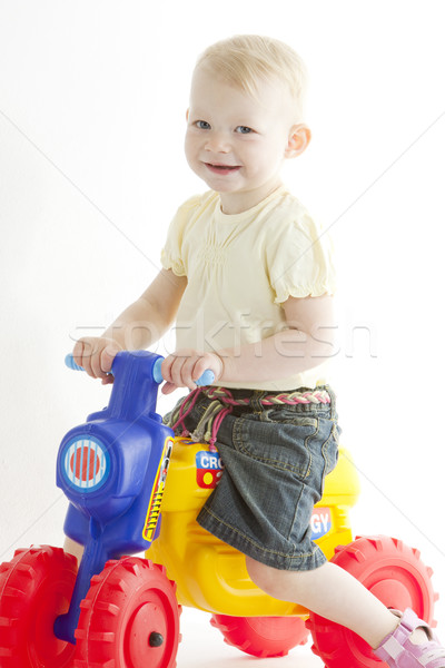 little girl on toy motorcycle Stock photo © phbcz