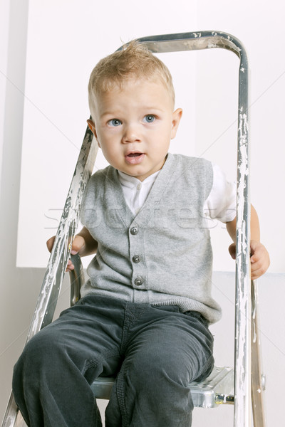 portrait of little boy sitting on stepladder Stock photo © phbcz