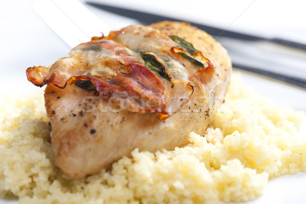 chicken meat on sage baked with bacon and served with couscous Stock photo © phbcz