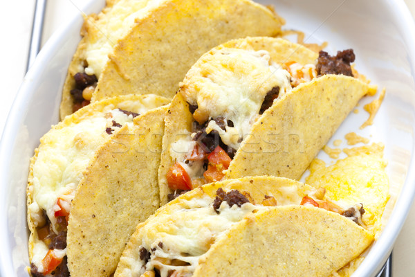 baked tacos filled with minced beef meat, beans and tomatoes Stock photo © phbcz