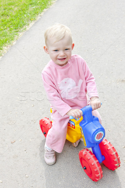little girl on toy motorcycle Stock photo © phbcz