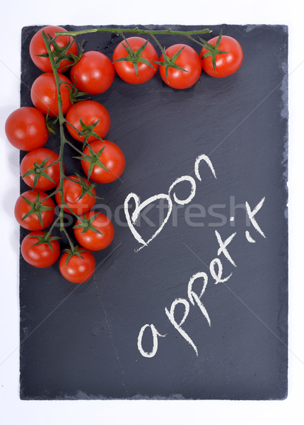 Bon appetit on a blackboard with tomatoes Stock photo © philipimage