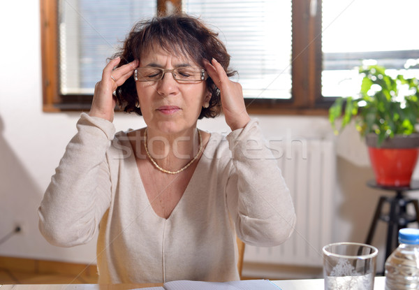 woman in the office has a headache Stock photo © philipimage