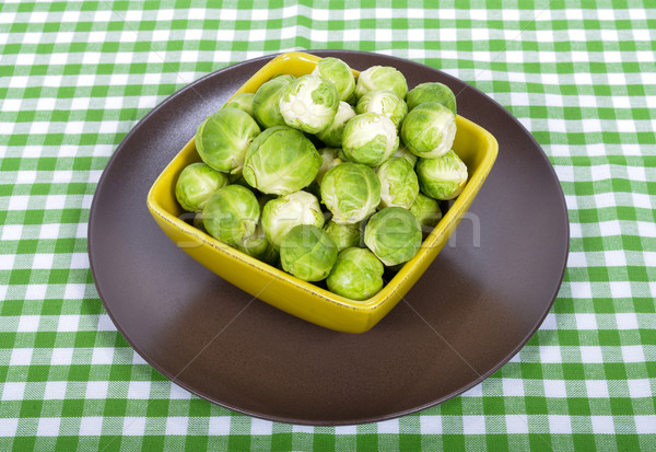 Brussels sprouts in a brown plate on green towel Stock photo © philipimage