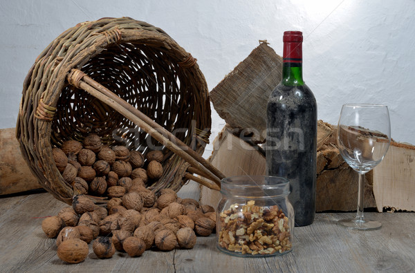 old bottle of wine with a basket of nuts Stock photo © philipimage