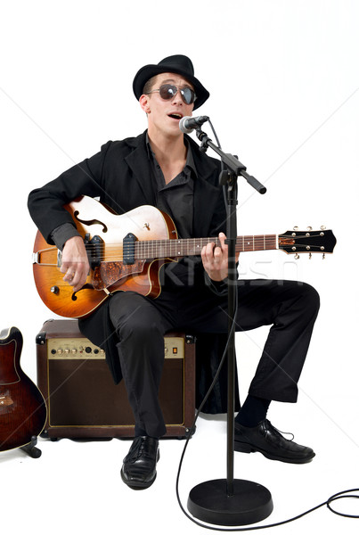 the guitarist sings sitting on an amplifier Stock photo © philipimage