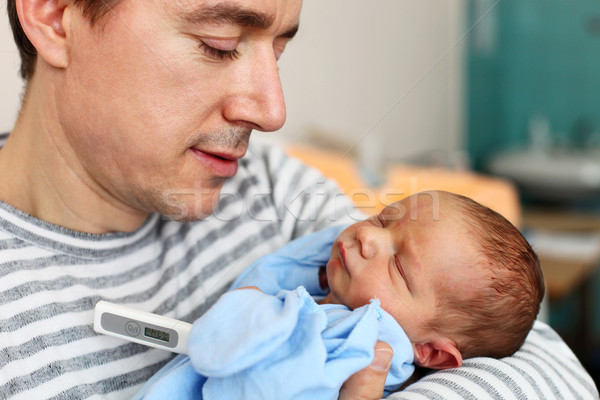 Stock photo: Father and newborn son with thermometer