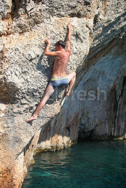 Deep water soloing, rock climber on cliff Stock photo © photobac
