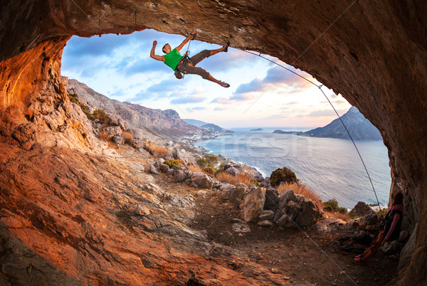 Erkek kaya tırmanma çatı mağara gün batımı Stok fotoğraf © photobac
