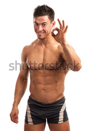 Muscular man showing ok sign isolated over white Stock photo © photobac