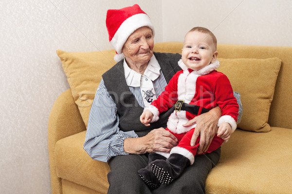 Baby boy in Santa costume with his grandmother Stock photo © photobac