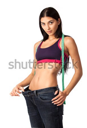 Astonished young woman in old jeans pants Stock photo © photobac