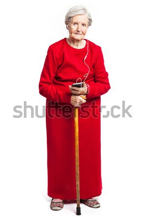 Stock photo: Senior woman listening to music over white