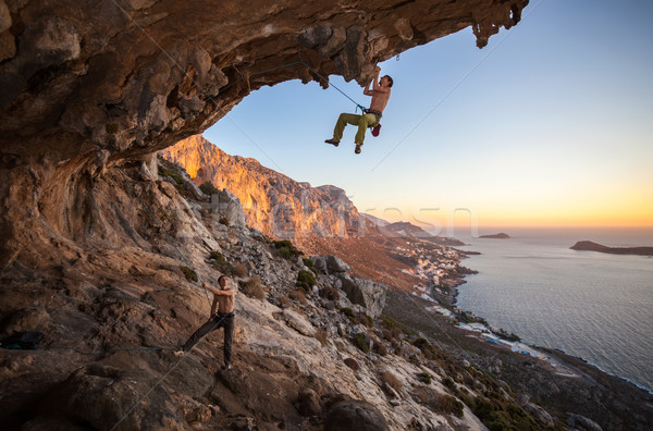 Male rock climber climbing on a roof in a cave Stock photo © photobac