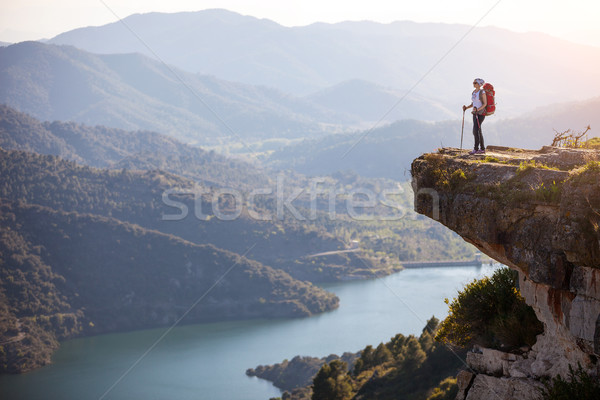 Female hiker standing on cliff and enjoying view Stock photo © photobac