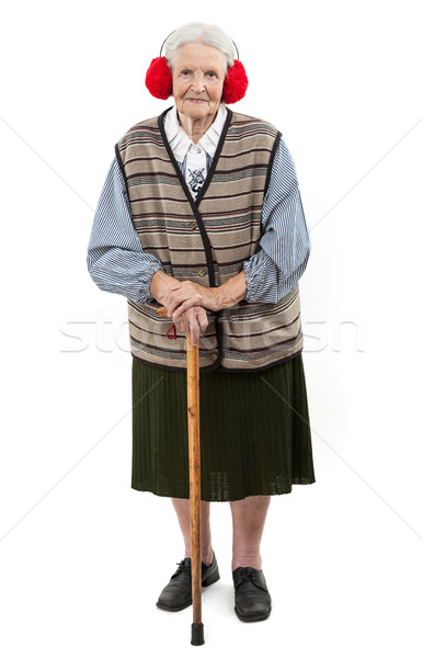 Old woman with a cane wearing faux fur ear muffs Stock photo © photobac