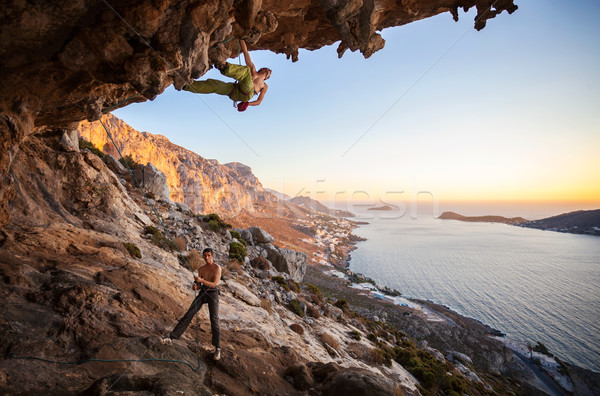 Male rock climber climbing on a roof in a cave Stock photo © photobac