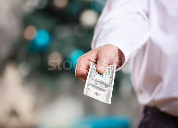 Hand with money on a Christmas background Stock photo © photobac