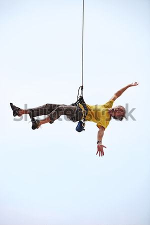 Happy rock climber hanging on rope Stock photo © photobac