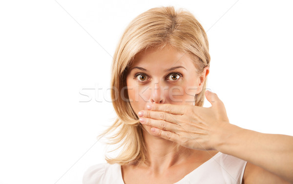 Amazed young woman covering mouth on white Stock photo © photobac