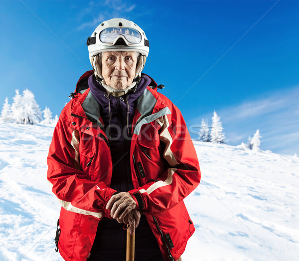Senior woman wearing ski jacket on snowy slope Stock photo © photobac