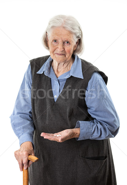 Senior woman holding medications over white Stock photo © photobac