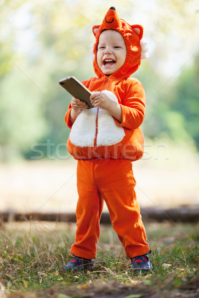 Kisgyerek fiú róka jelmez tart okostelefon Stock fotó © photobac