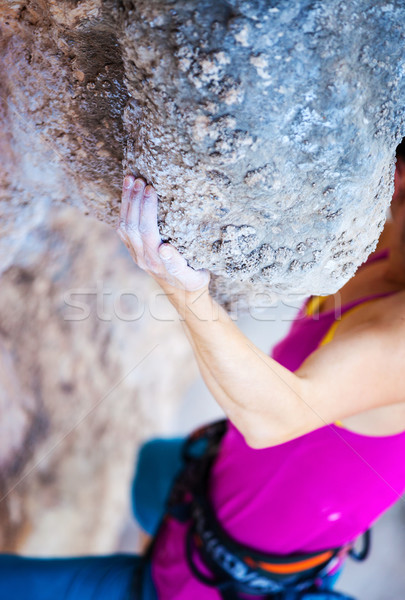 Cropped view of young woman climbing natural cliff Stock photo © photobac