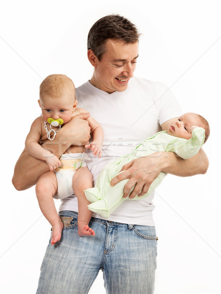 Stock photo: Smiling young man with two baby boys over white