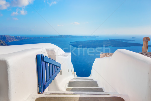 Santorini, Greece. Open blue door with Aegean sea view and Caldera. Stock photo © photocreo