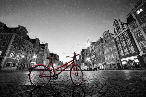 Vintage red bike on cobblestone historic old town in rain. Wroclaw, Poland. Stock photo © photocreo