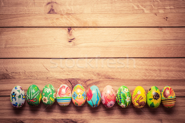 Colorful hand painted Easter eggs on wood. Unique handmade, vint Stock photo © photocreo