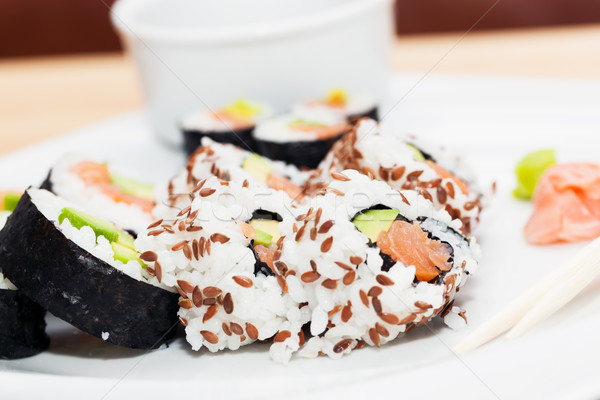 Sushi with salmon, avocado, rice in seaweed served with wasabi and ginger.  Stock photo © photocreo
