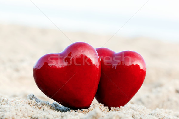 Two red hearts on the beach symbolizing love, Valentine's Day, romantic couple Stock photo © photocreo