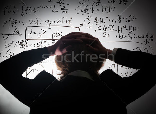 Student holding his head looking at complex math formulas on whiteboard. Problem to solve Stock photo © photocreo