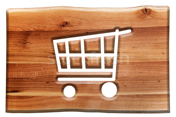 Shopping cart sign, symbol cut in wooden board isolated on white. Stock photo © photocreo