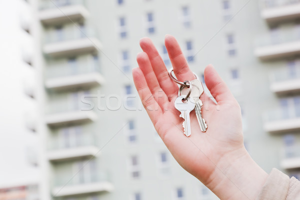 A real estate agent holding keys to a new apartment in her hands. Stock photo © photocreo