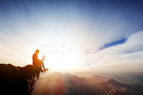 Man working on notebook on top of the mountains. Internet freedom Stock photo © photocreo