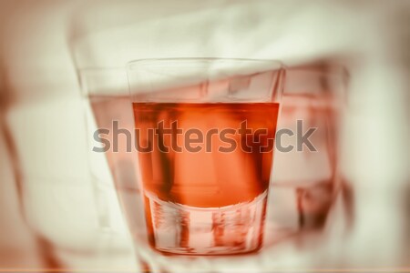 Abstract first person perspective of being drunk and reaching for another glass of alcohol. Stock photo © photocreo